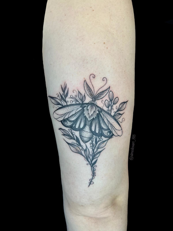 Black, grey and white fine line detailed thigh tattoo of a moth amongst leaves tattooed by Lita Almodovar of Sacred Mandala Studio in Durham, NC.